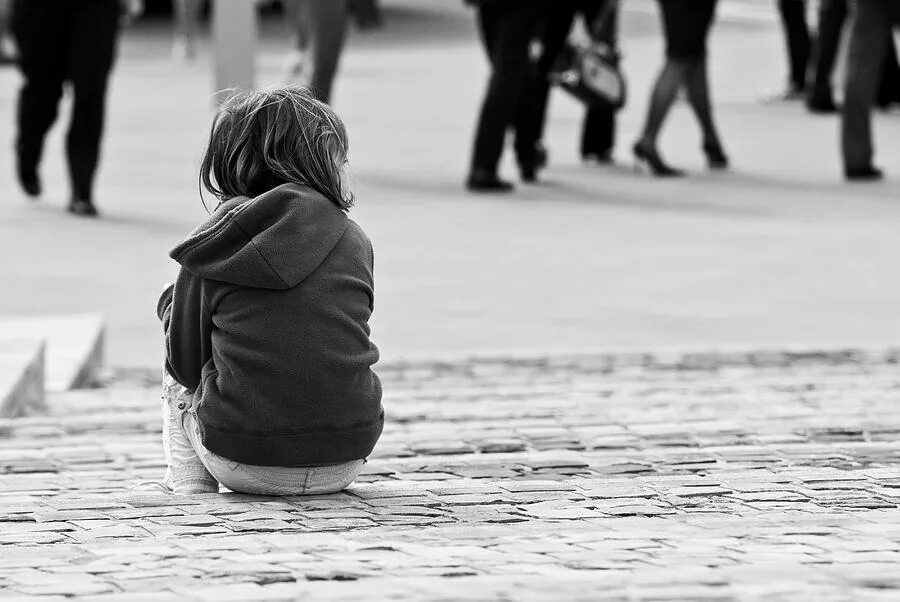 Alone in a crowd. Loneliness in the crowd. alone in the crowd. lonely girl in a crowd. lonely person lost in the city crowd.