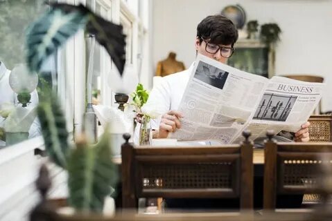 He is reading a newspaper now