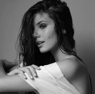 black and white photograph of a woman with her arms folded over her shoulde...