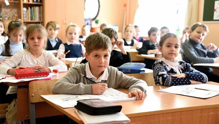 В какие смены учатся классы в школе. Ученик за партой. Школьники за партой. Младшие школьники. Дети сидят за партой в школе.