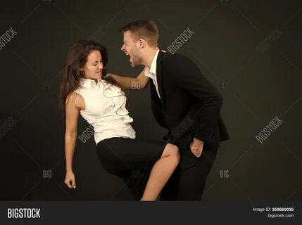 Woman kicking man in the balls