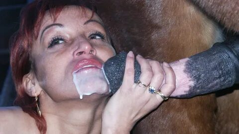 Lustful well-fit MILF moans as a horse unloads warm cum in her mouth.
