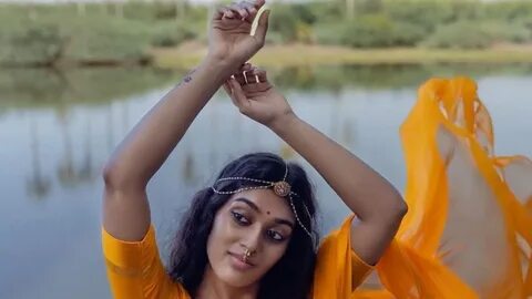 Niyathi is seen wearing a plain yellow saree with a nath and a simple matha...