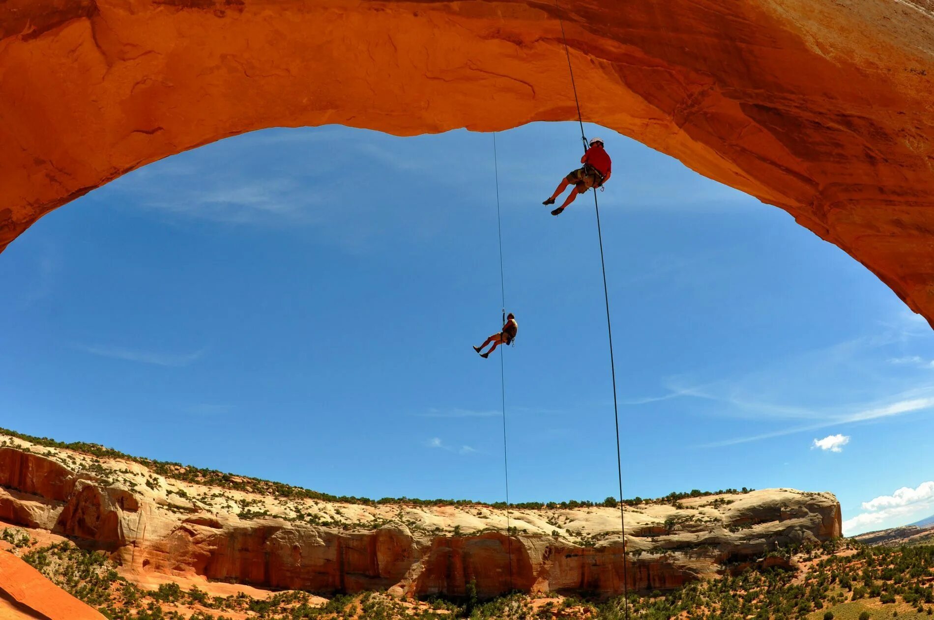 Climber. Outdoor Adventure. Rappelling. Climber in Orange. Rock climbing is the most dangerous