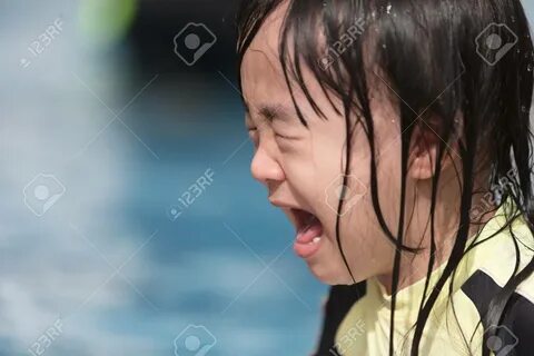 Asian Little Chinese Girl crying in Swimming Pool outdoor - 101671065.