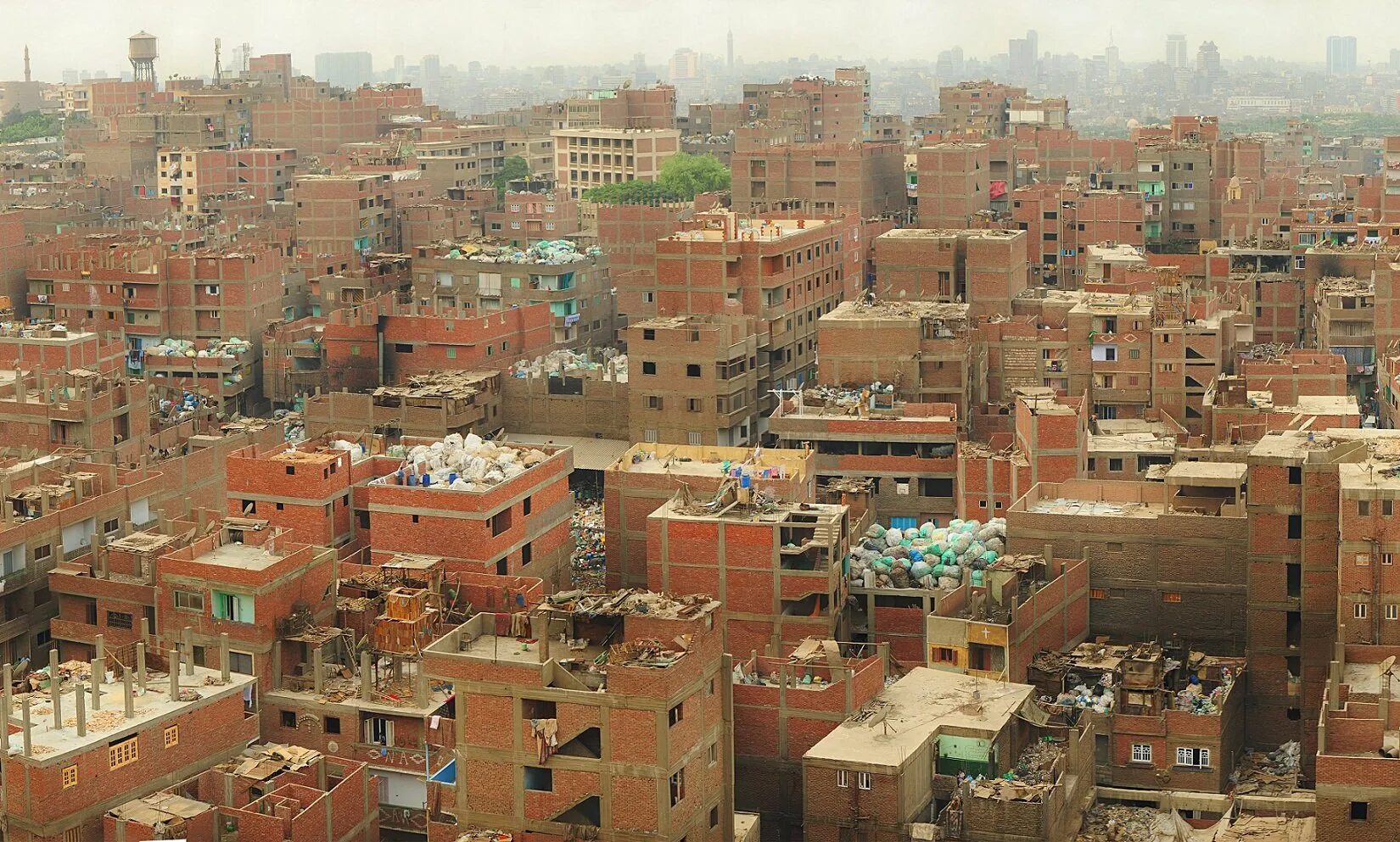 Страна 1000 городов. Маншият-Насир Египет. Маншият-Насир город мусорщиков. Маншият Насир мусорный город. Город мусорщиков в Каире.