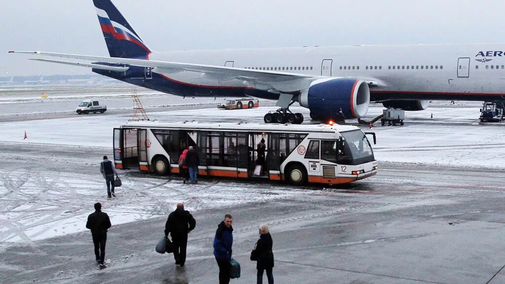 Посадка людей в самолет. Посадка пассажиров в самолет. Самолет зимой. Аэропорт посадка. Высадка пассажиров в аэропорту.