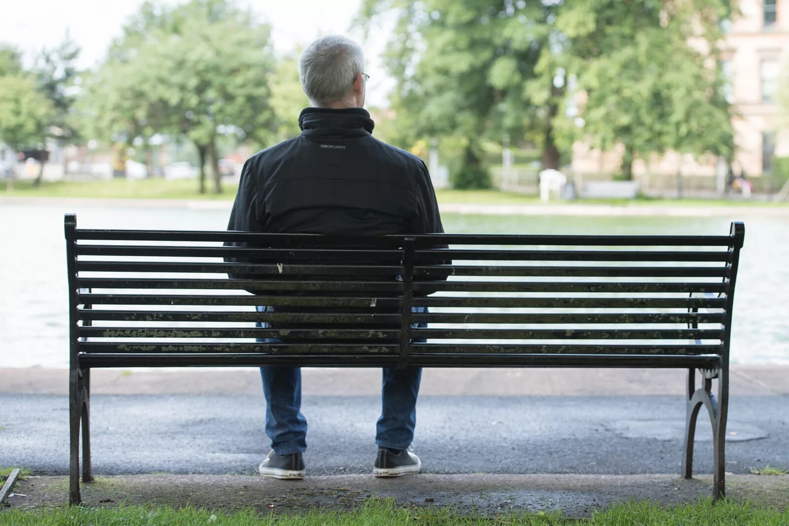 Sitting waiting. Man sitting on Bench. Man sitting and waiting. Man waiting on Bench. Sit on a bench