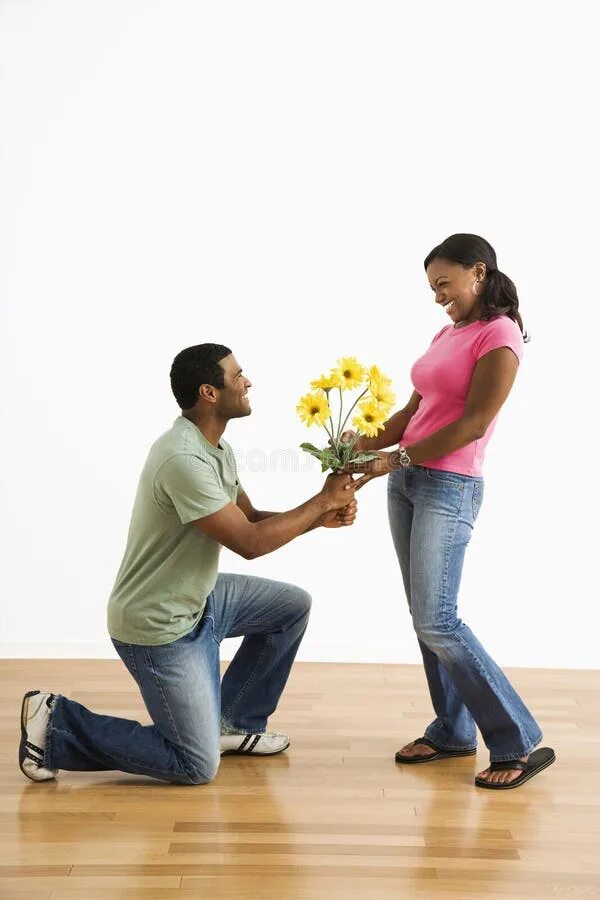 Happy Beautiful Young Woman Holding Bouquet of Mixed Flowers Standing Near the W