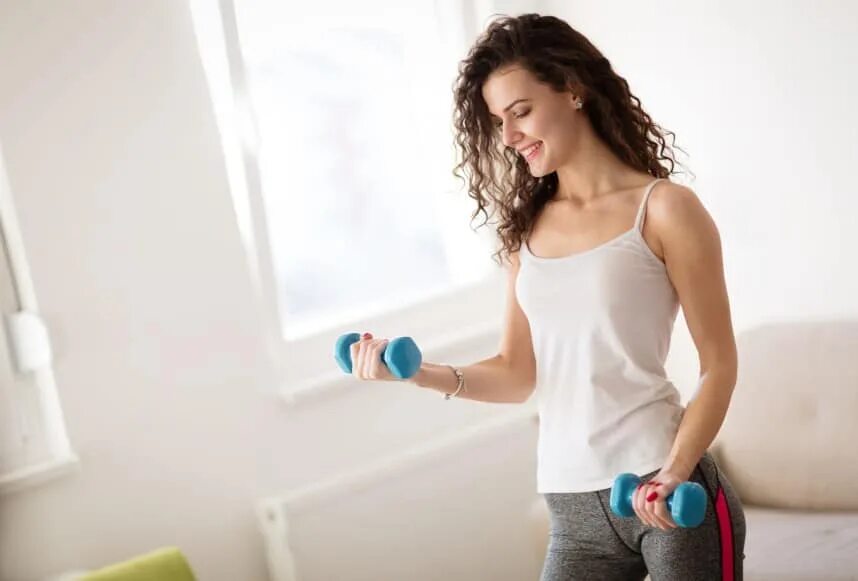 Stay Fit. Sports Beauties. Beautiful woman exercising at Home. Woman stay.