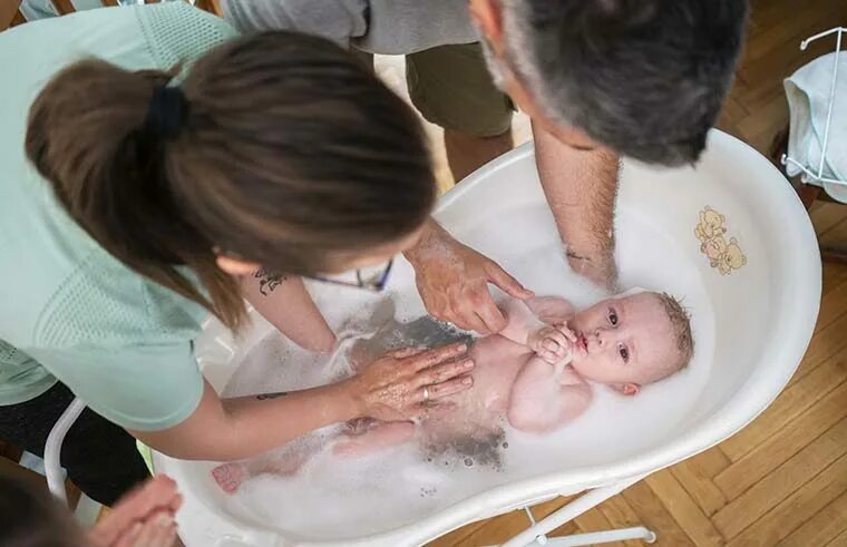 Mother Bathing Baby in Bathtub. Child penis