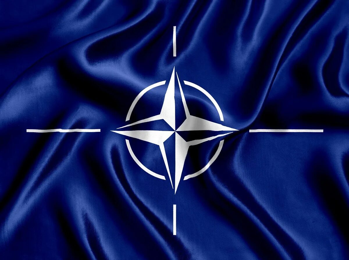 Нато санкт петербург. Флаг НАТО. Фляга НАТО. Эмблема НАТО. Фалиг НАТО.
