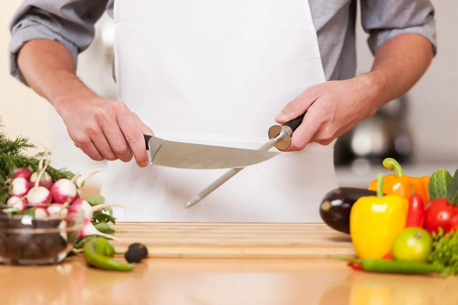 The scissors on the kitchen table. Повар точит нож. человек режет еду. sharpening kitchen knife.