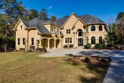 Two-story yellow Mediterranean mansion. 