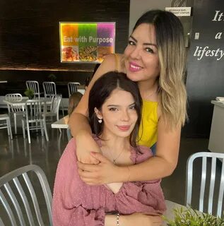 Nohemy is wearing pink dress and posing for the picture with her aunt. 