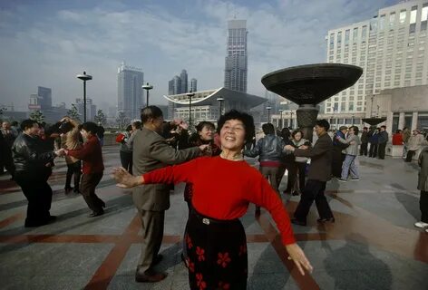 Early morning dancing on People's Square with the new Opera house desi...