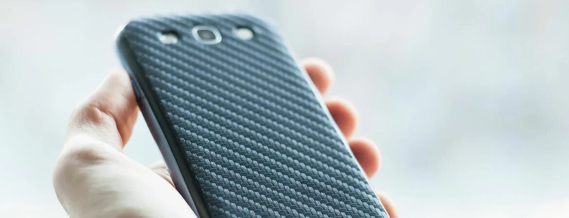 Carbon back Cover. X back frame Case for smartphone. Cases with Prints for smartphones in hands. Back mobile