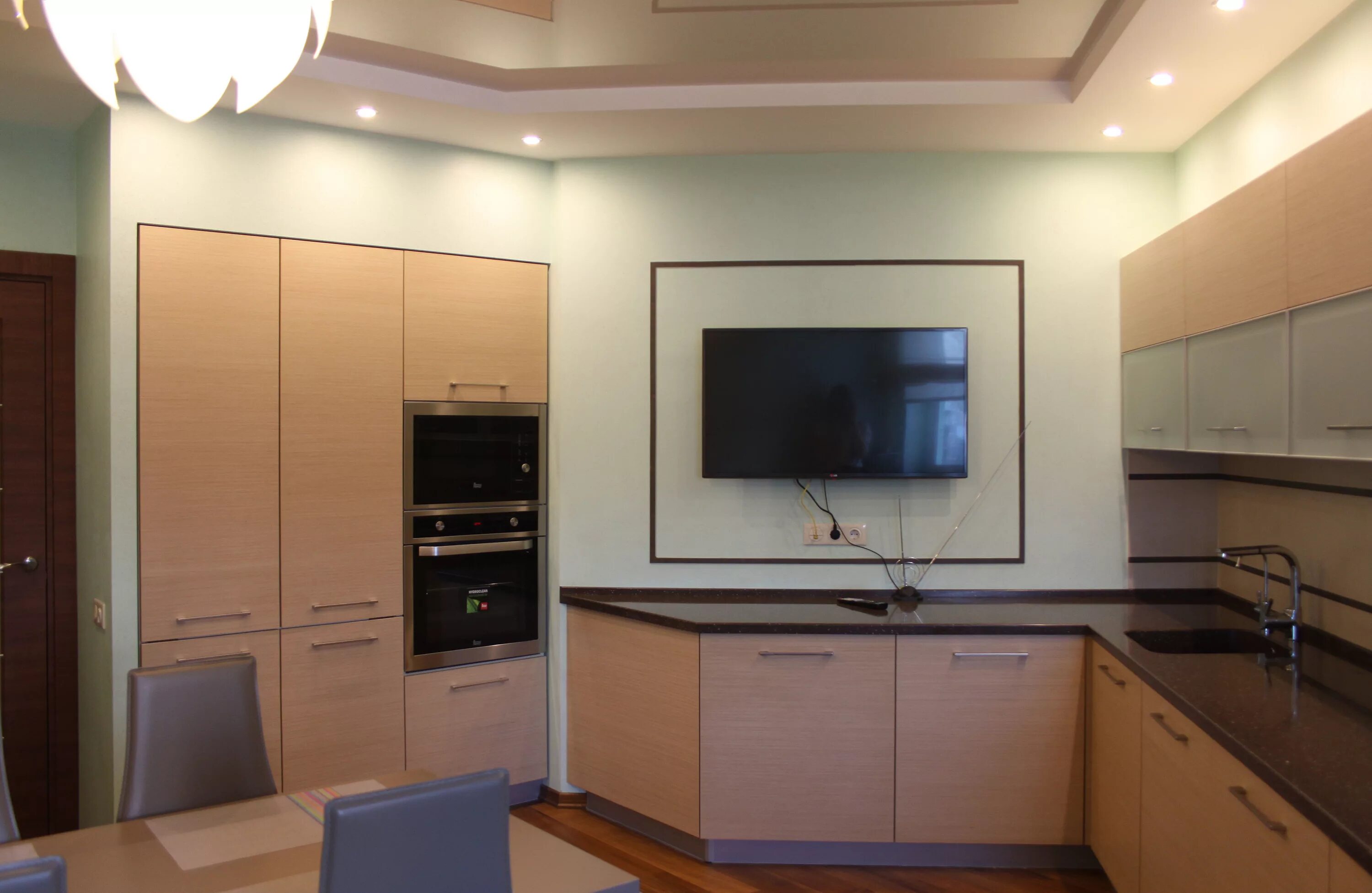 Кухня со встроенным телевизором. Телевизор на кухне. Большой телевизор на кухне. Кухонный гарнитур с телевизором.
