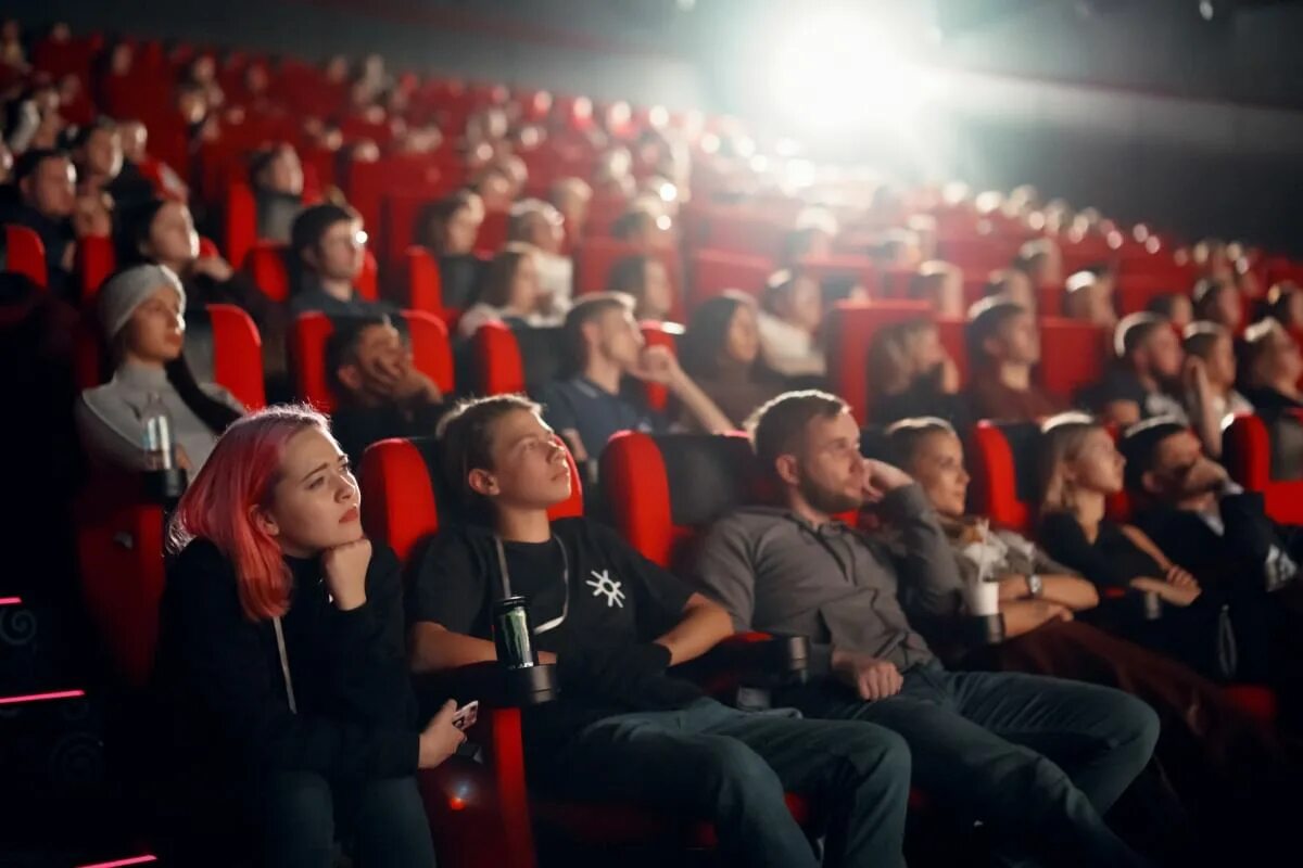 тифлокомментирование в театре. кинотеатр. зал кинотеатра с людьми. экран кинотеатра. показ кинофильма.