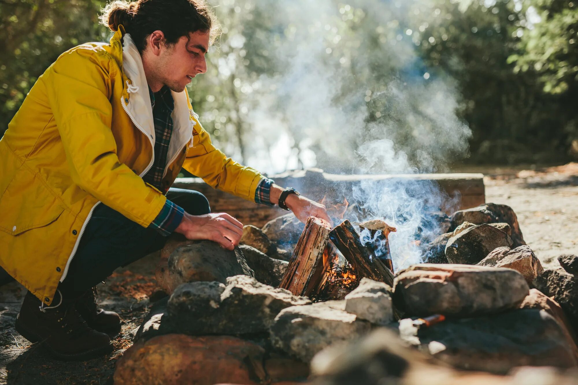 Put on the fire. Build a campfire. put out a campfire. put out a fire. a man warming up in a fire.