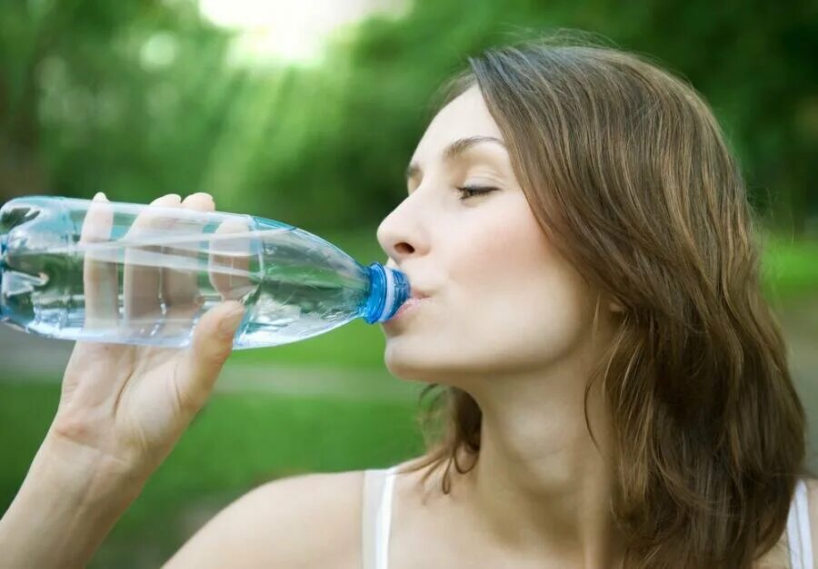 Жажда. Питье воды. Девушка пьет минеральную воду. Жажда воды. Пить больше воды.