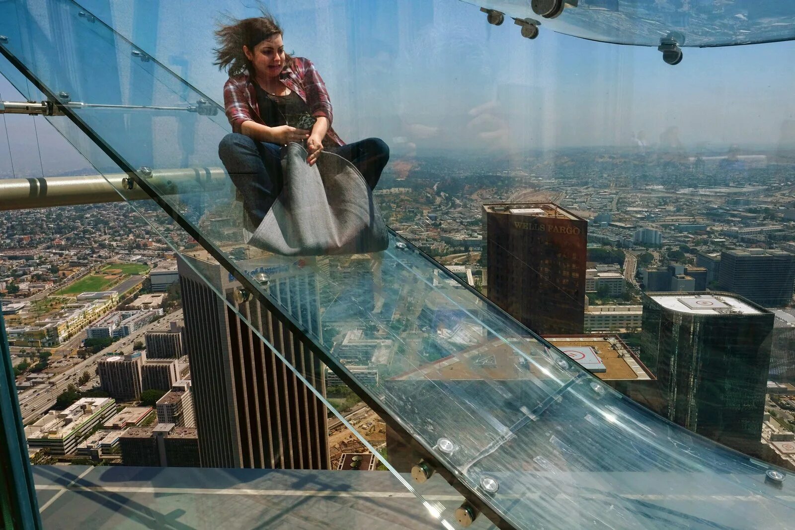 Стоит огромная стена. Стеклянная горка Skyslide, Лос-Анджелес, США. Прозрачная горка на высоте 300 метров на стене. Skyview Дубай горка. Смотровая в Лос Анджелесе.
