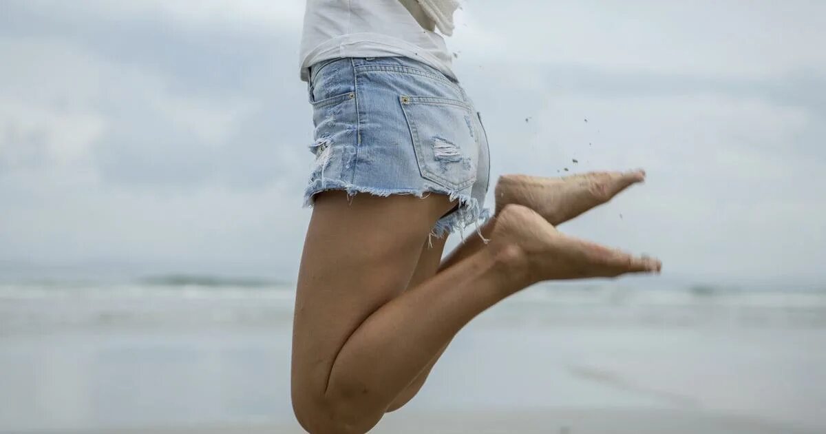 Ноги снизу вверх. Девушка в джинсах в прыжке. Ладонь в море в джинсовой. Девушка прыгает в джинсах. Девушка сидит фото снизу.