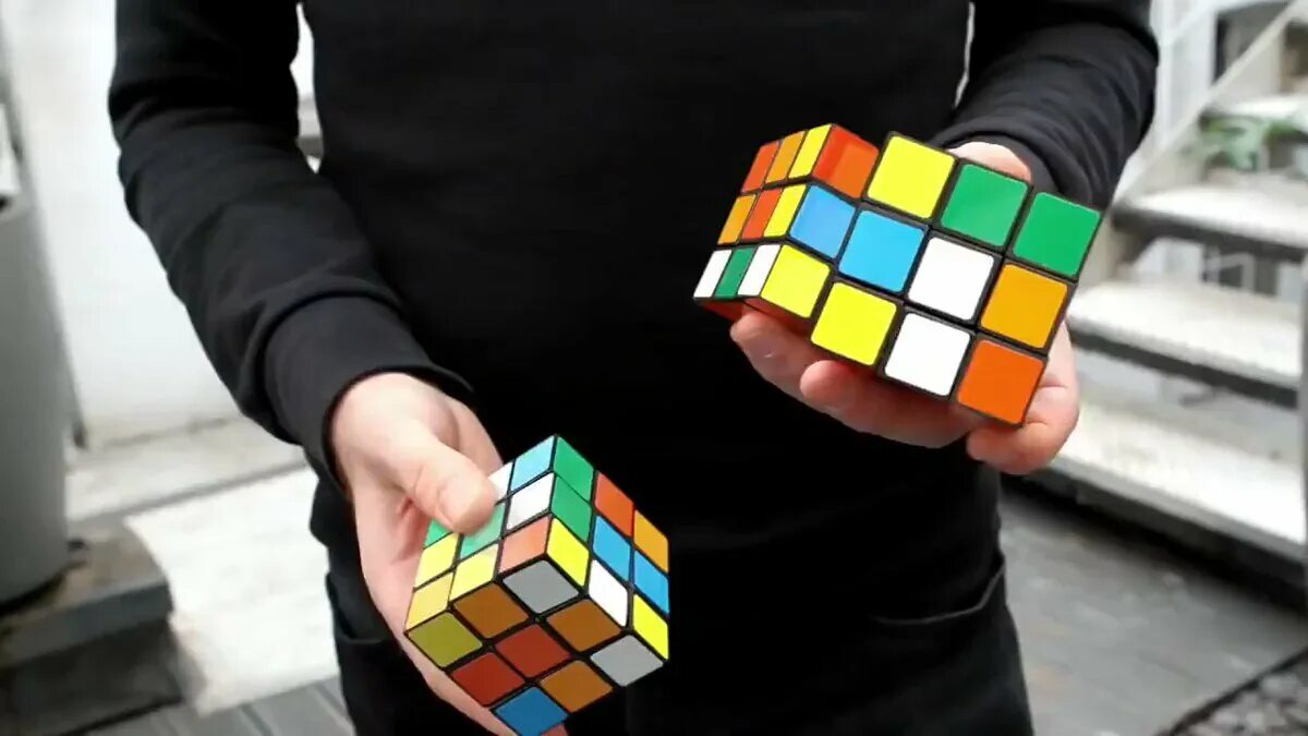 Включи рубик. Кубик Рубика. Человек с кубиком рубиком. Кубик Рубика картинки. Изображение кубика Рубика.