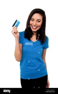Young pretty smiling asian girl showing her credit card to the camera. 