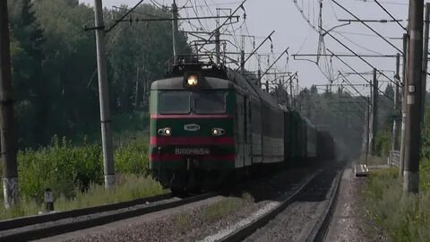 Электровоз с грузовым поездом приветливый машинист