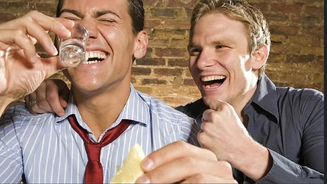 Пить в любое время. Два пьющих человека. Мужчины выпивают. Мужчина смеется. Выпивающие люди.