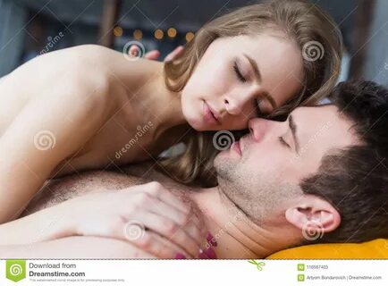 Photo about Sensual loving couple in the bedroom making love. 