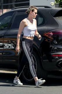 kristen stewart rocks a white crop top and black adidas leggings while.