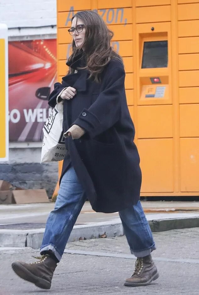 Keira Knightley displays her baby bump in a full-length floral dress as she step