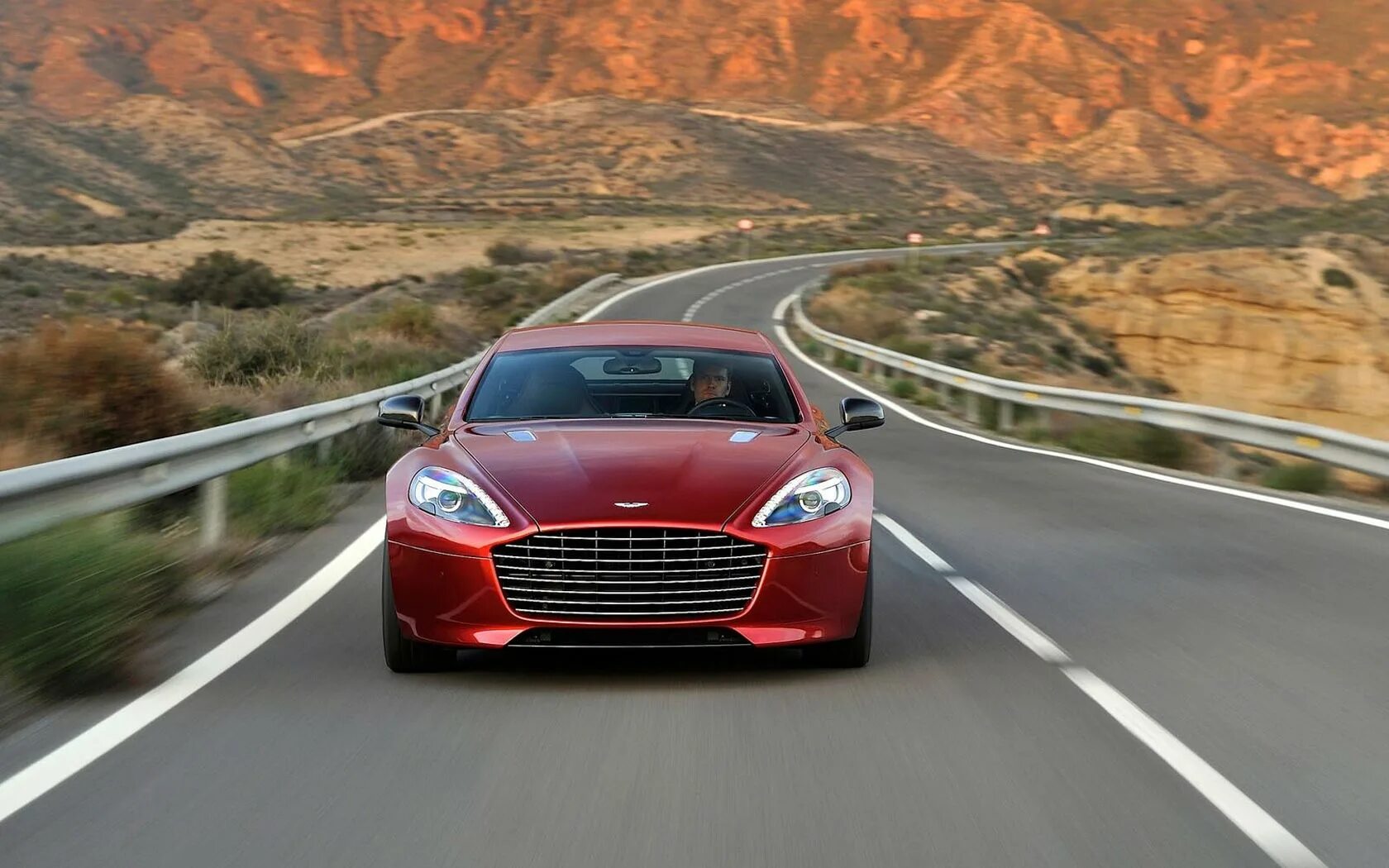 Машина едет фото. Aston Martin rapide s 2021. Спортивный седан Астон Мартин. Астон Мартин на горе. Машина на дороге.