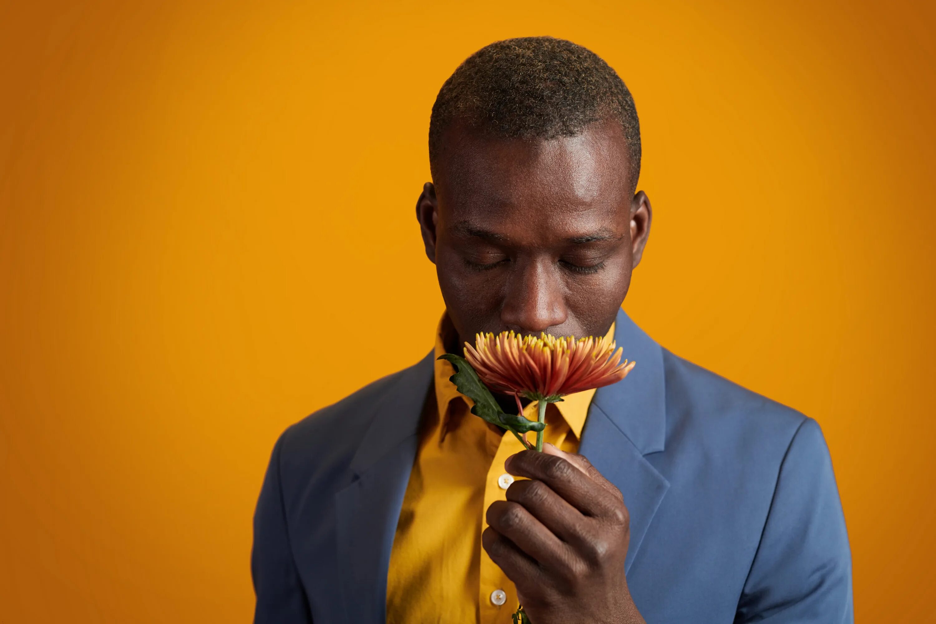 Why you smell this flower. Man smelling a flower.