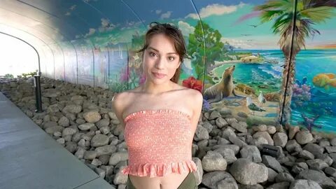 She shows off her ripe titties in public when she pulls down her tube top! 