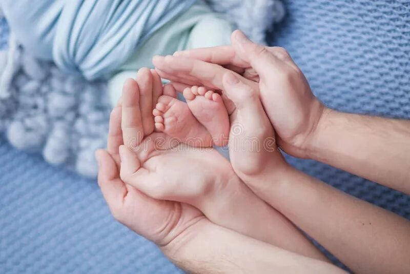 Малыша и его родителей на. Ножки малыша в руках родителей. ножки новорожденного. ножка новорожденного в руке. ребенок на руках.