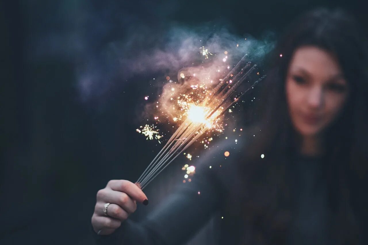 фейерверк в руках. девушка с бенгальским огнем. держит бенгальский огонь. волшебство в руках. бенгальские огни.