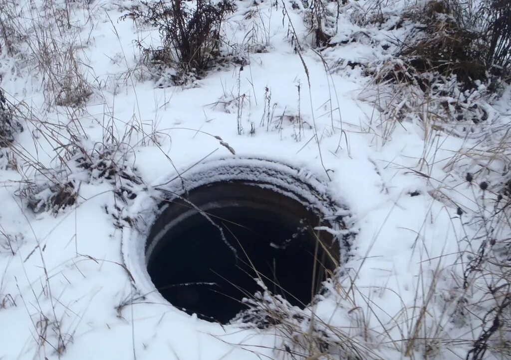 Колодец зимой. Открытый колодец. Колодец на улице. Городской колодец. Увидел открытый люк