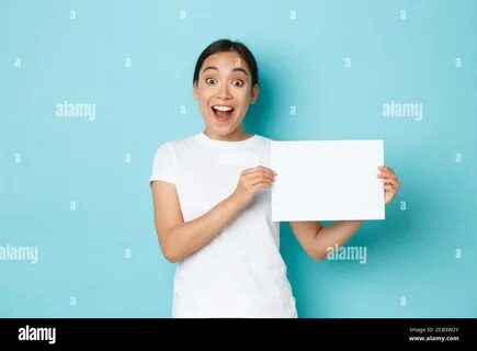 asian girl in white t-shirt, making announcement, gasping surprised while s...