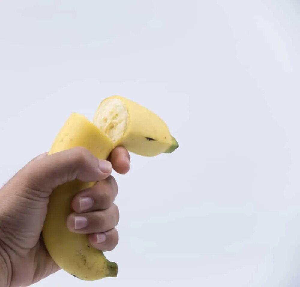 Сломанный банан. Сломанный банан в руке. Банан сломался. Банан разбили.