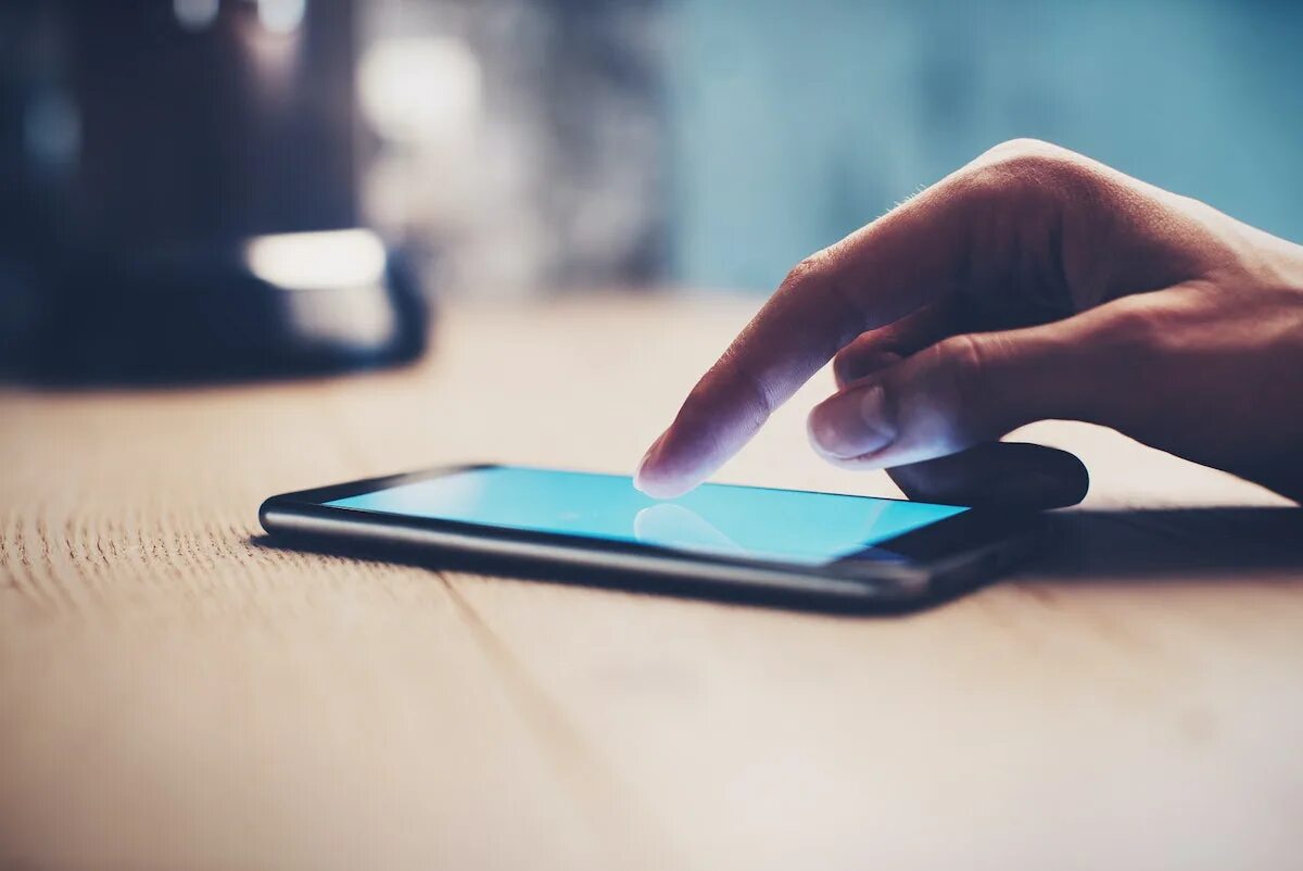 The phone is the table. Smartphone on the table. phone on table. phone on the table picture. put the phone on the table.