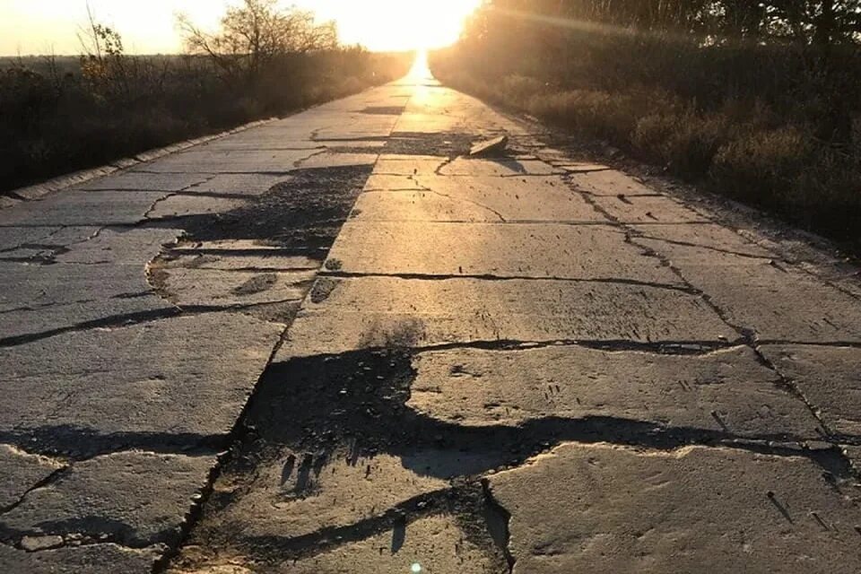 Улица никуда. Разбитая дорога. Потрескавшаяся дорога. Ямы на дорогах. Трещины на дороге.