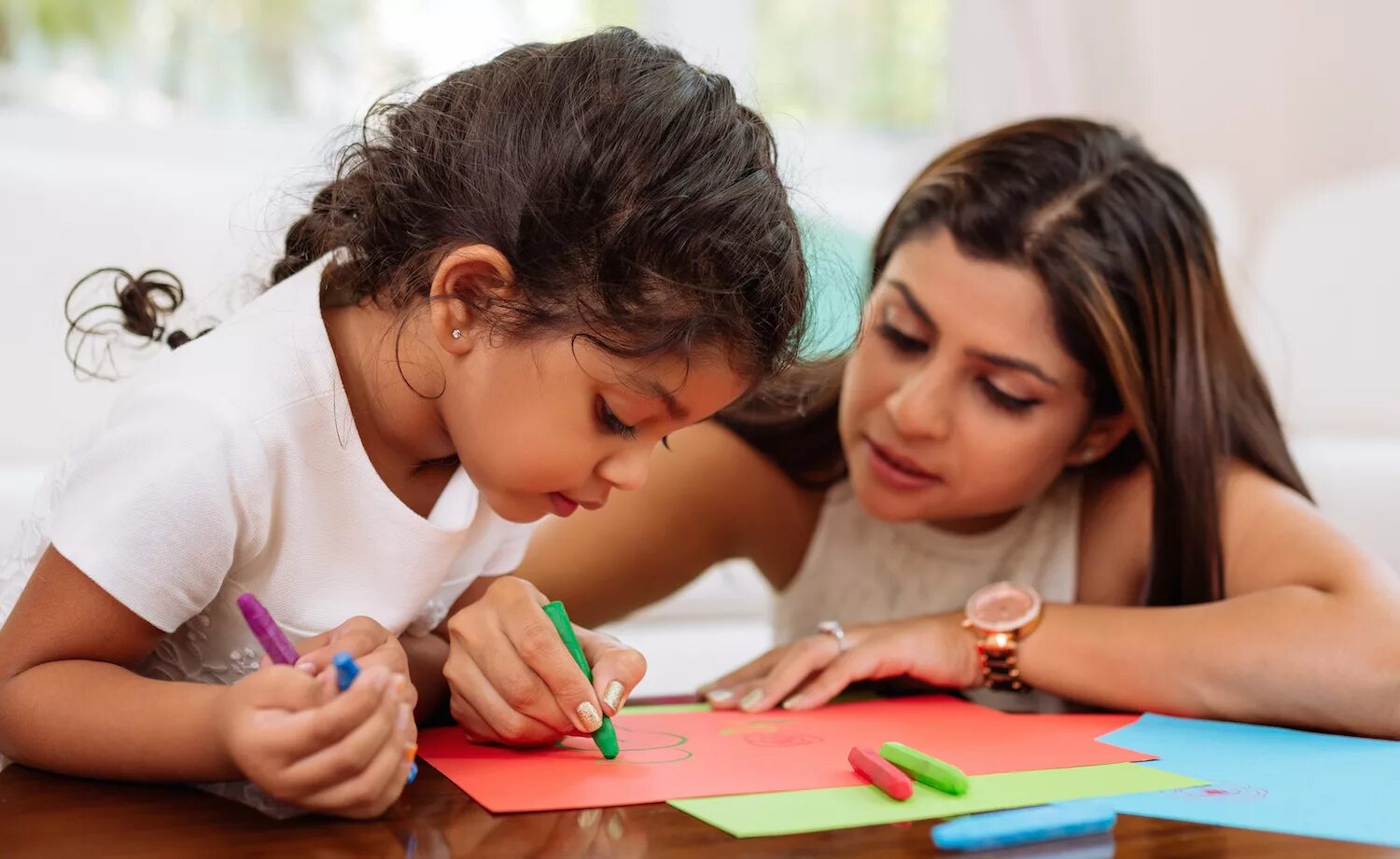 Watch are the children doing. Parents writing. Financial Literacy and children Art. A mother talking to her child homework. Indian teacher.