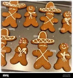 A bouquet of orange lilies and a skull decorate a tabletop for Halloween. 