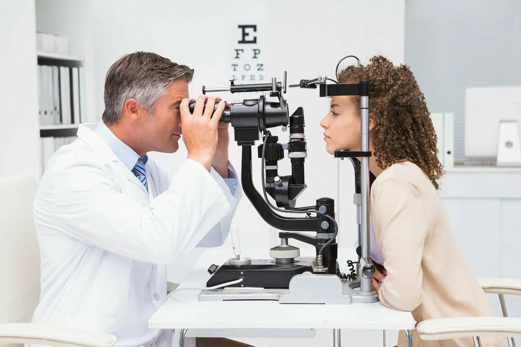 Человек проверяющий зрение. Окулист. Врач офтальмолог. Осмотр офтальмолога. Обследование у офтальмолога.