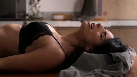 And in it Aislinn Derbez lying on her back showing cleavage in her bra as s...