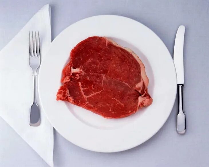 В мясе есть кровь. Сырое мясо на тарелке. Кусок мяса на тарелке. Кусок сырого мяса на тарелке.