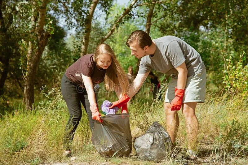 Picking up women. Picking up the rubbish picture. Picking up rubbish White Black. A photo PF people Tidying. Volunteer to participate in the collecting rubbish event on the Beach.